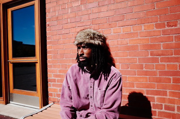 A man is sitting outside on a bench.