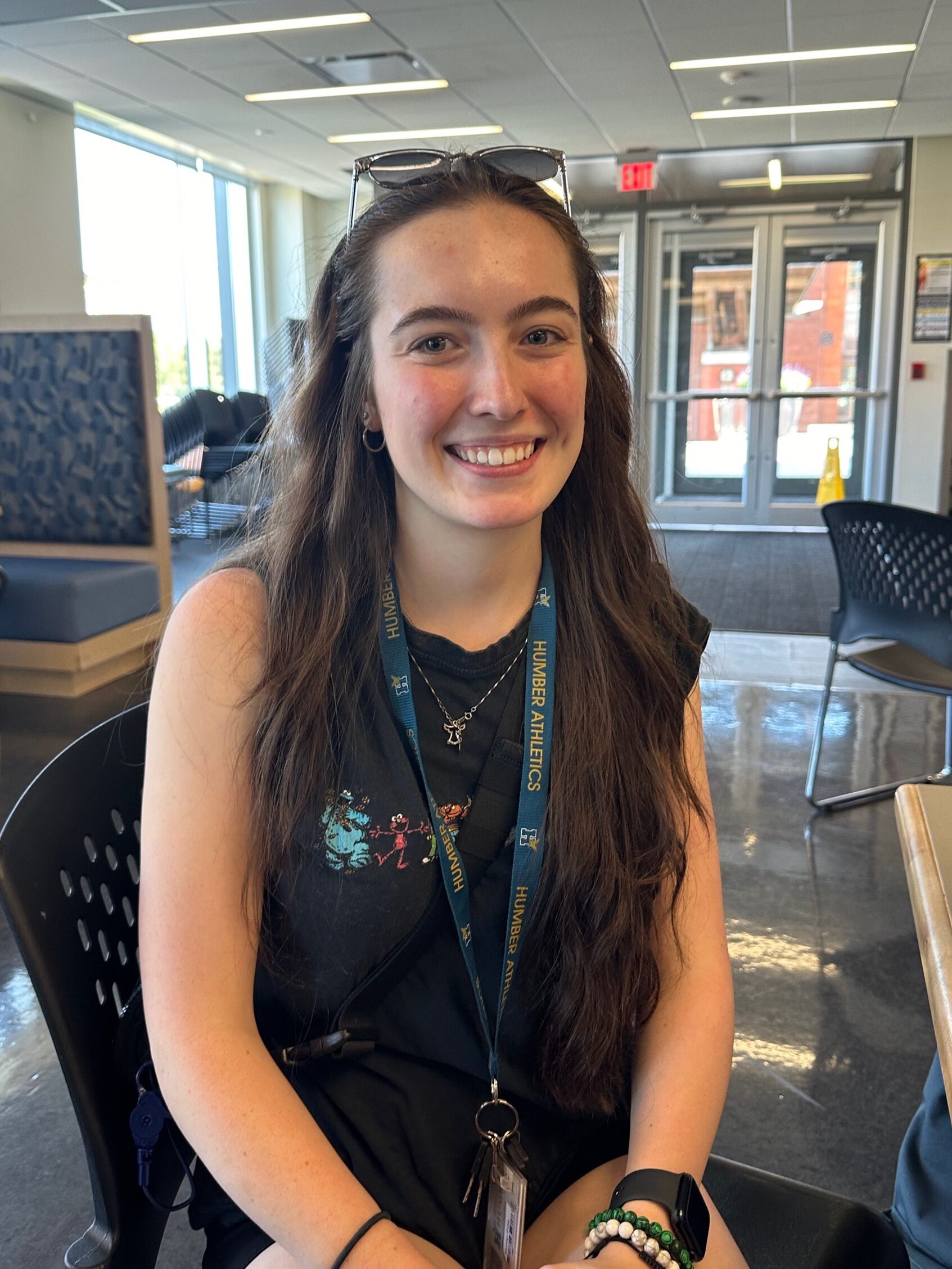 Headshot of student Hunter Futa sitting at a table located in the Lakeshore campus cafeteria.