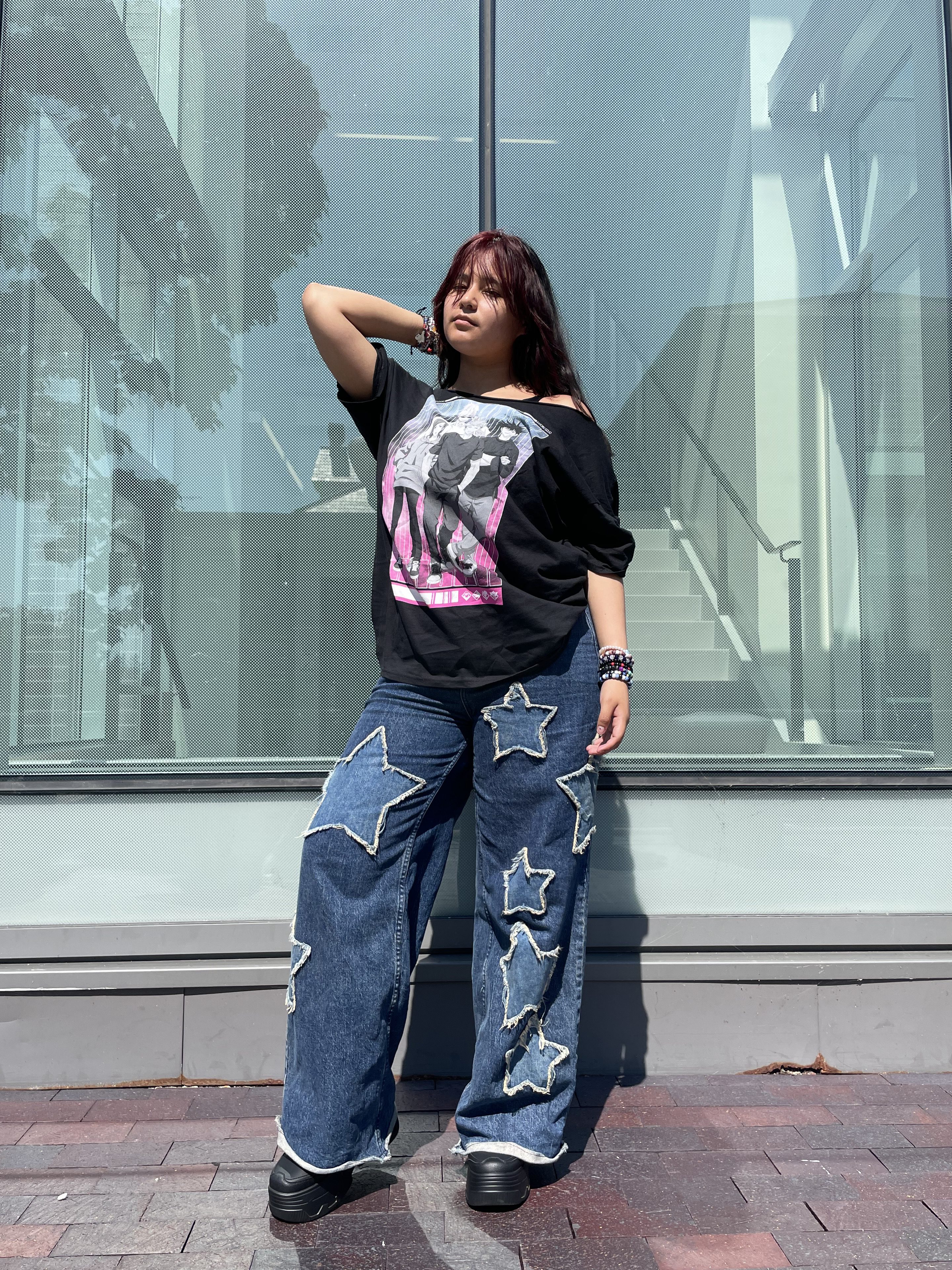 Streetwear style showing star pants, chunky goth boots and anime shirt