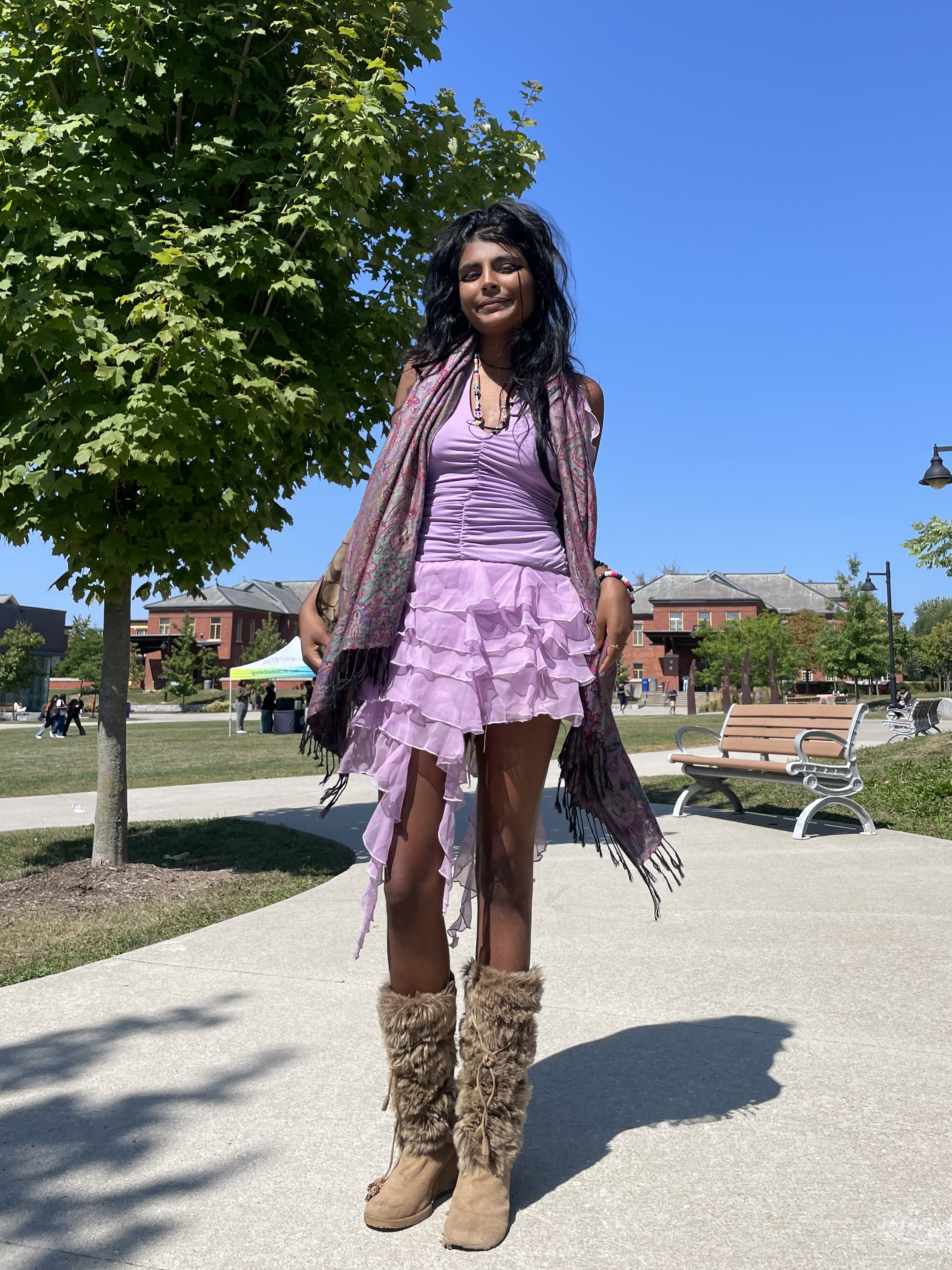 Y2K fashion trend with butterfly dress, chunky fur boots and rave makeup inspired look