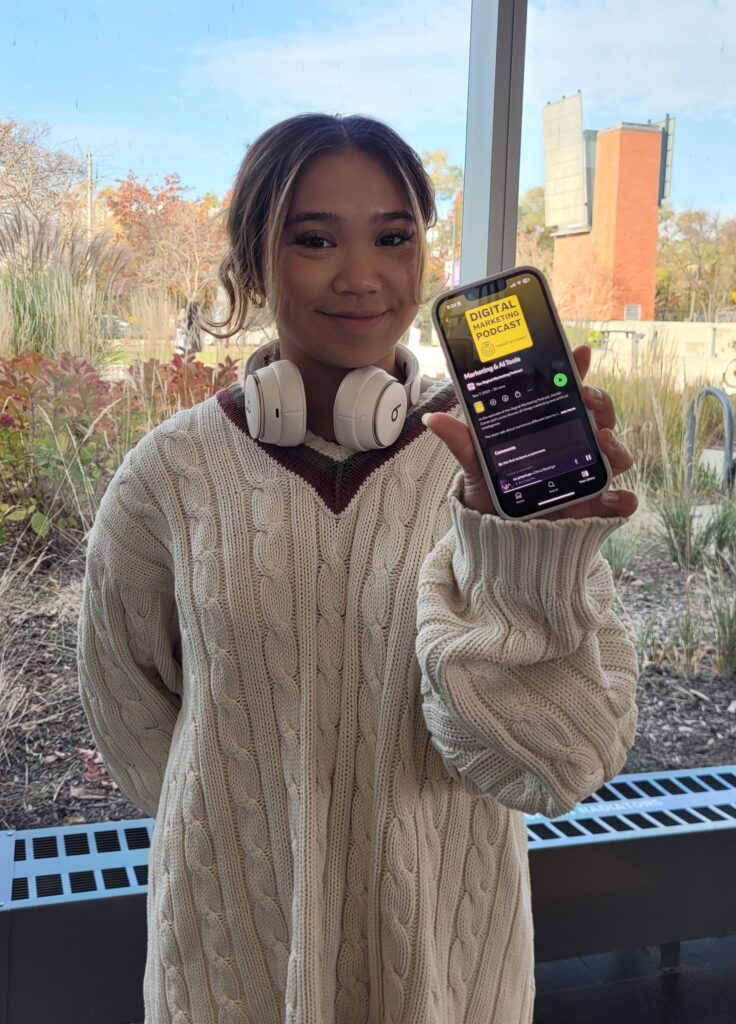 Picture of Kc Cojaungco Asube holding an iPhone and showing a podcast she listens to.