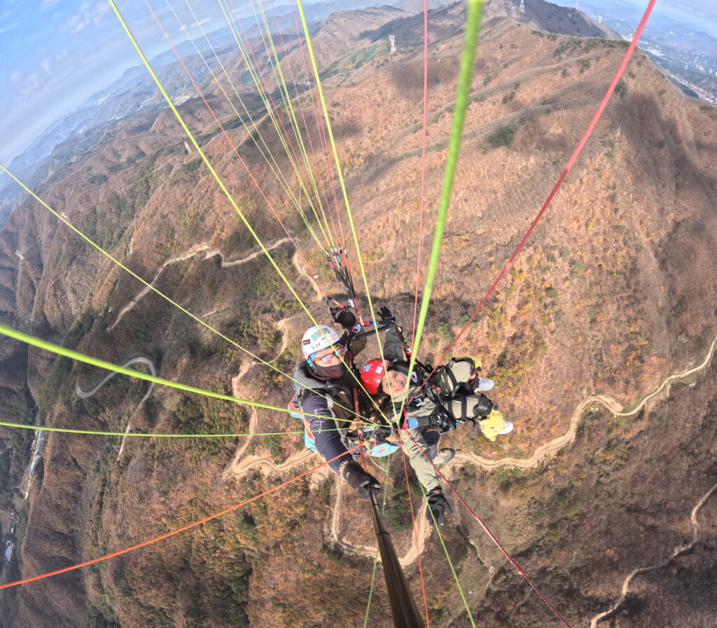 A girl and a boy doing a paragliding.