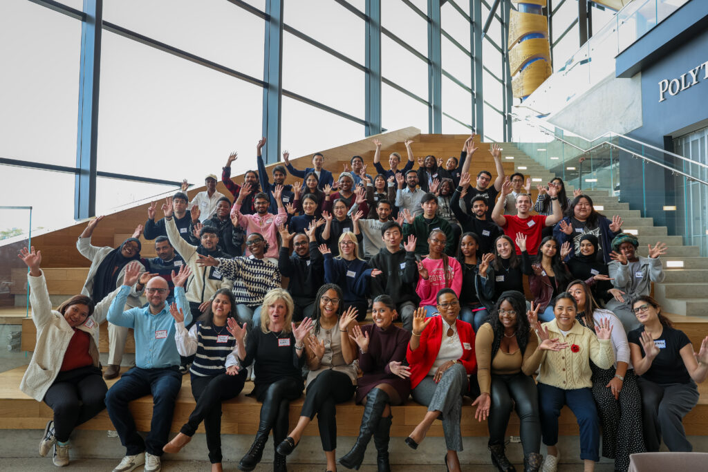 Students and staff raised their hands for a group picture.