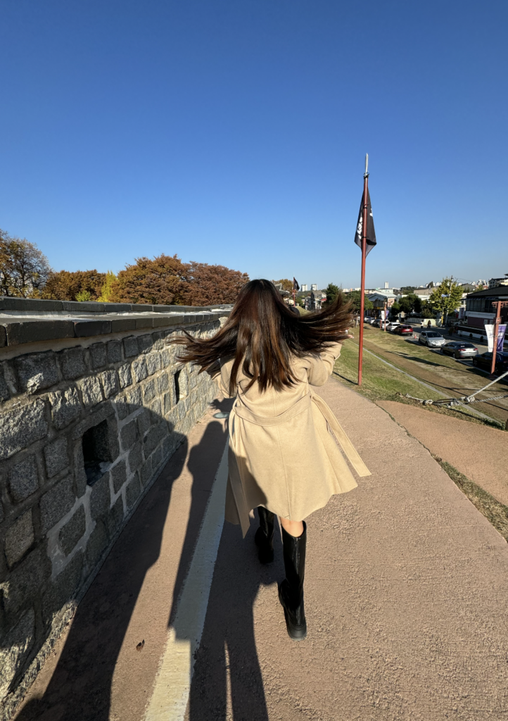 A girl walking under the sun.