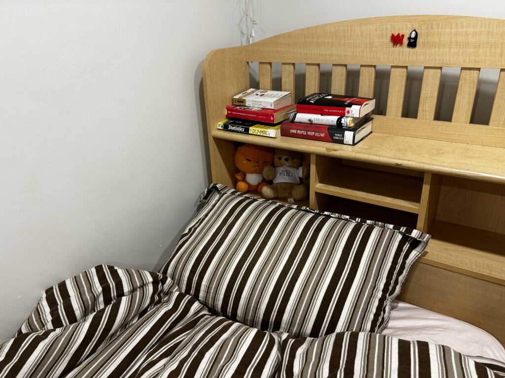 Headboard with a stack of books.