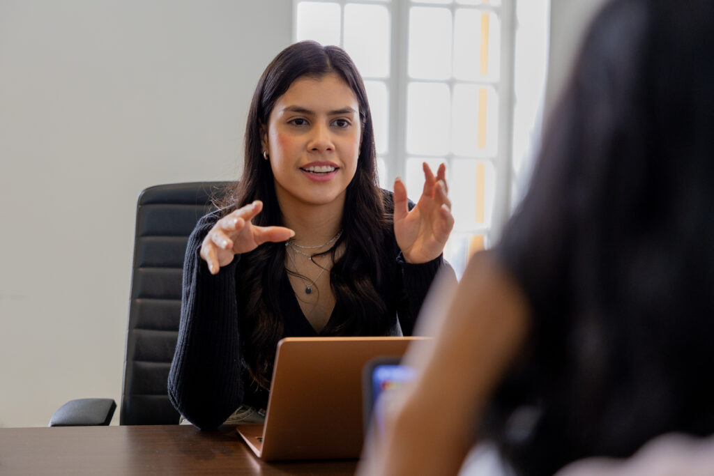 A person is explaining something to another while making hand gestures. 