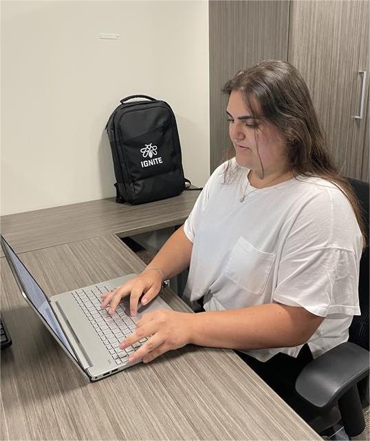 A woman is working on her laptop. 