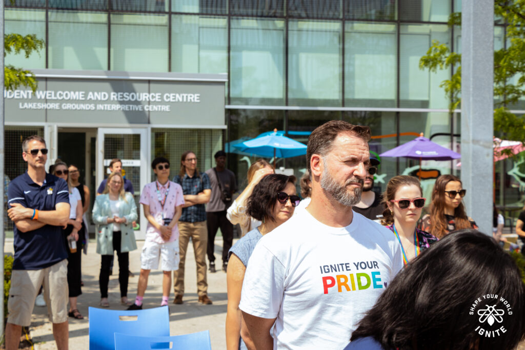 A group of people is standing around outdoors. 