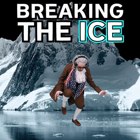 A person awkwardly dressed as Benjamin Franklin wearing black sunglasses and headphones dances on cracking ice with a snowy mountain behind him. 