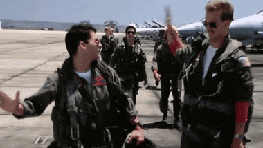 A clip from the Top Gun movie. Maverick and Goose share a high five while walking down the air strip.