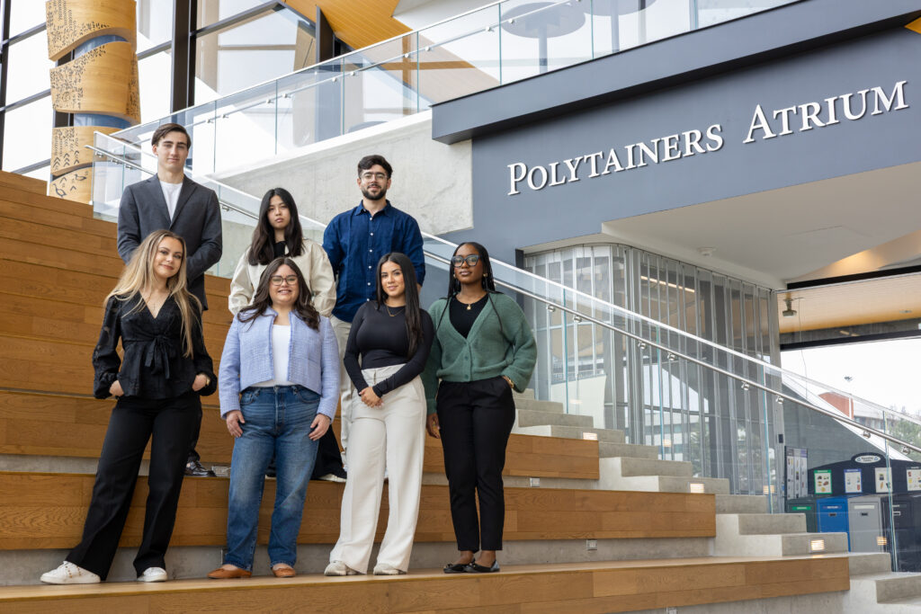 Seven board members standing on a staircase at the Humber Polytechnic North campus.