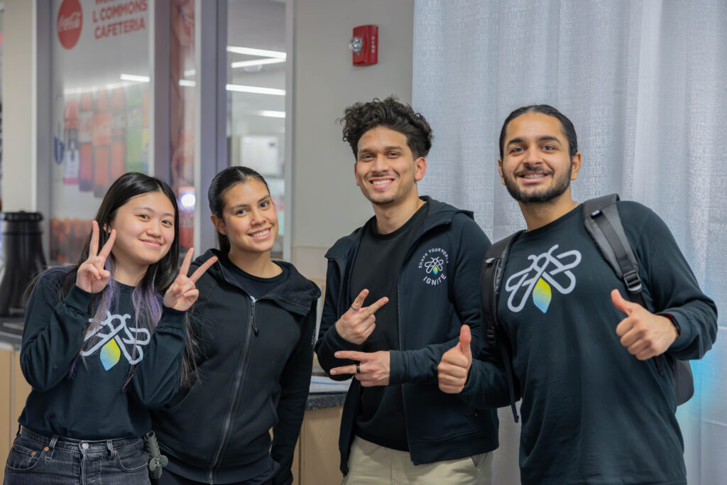 Four IGNITE staff smiling at the camera for a picture