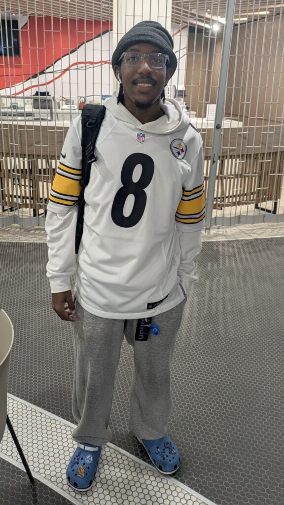 Daniel Douglas-Downer wearing a Pitsburgh Steelers jersey, crocks and videogame accessories