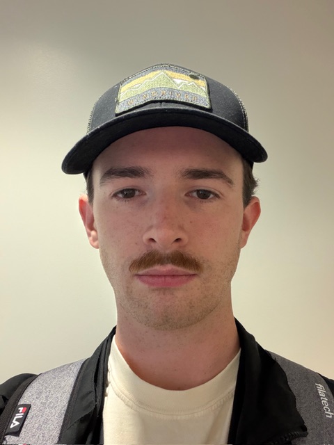 Image of a student looking into the camera for a photo, from the shoulders up.