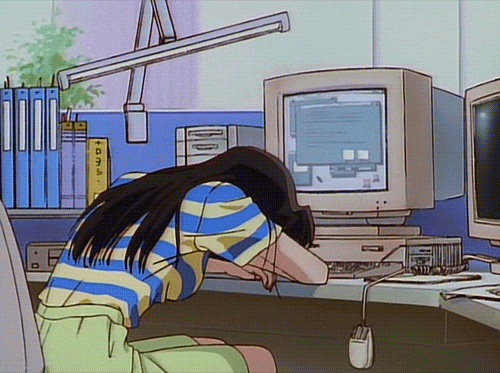 a girl napping at her work desk with a desktop and a mouse hanging by its cord