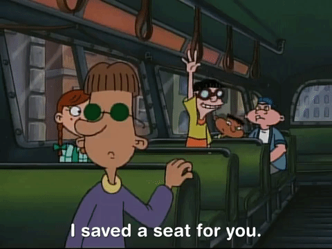 A cartoon boy waving his arm in a bus saying "I saved a seat for you."