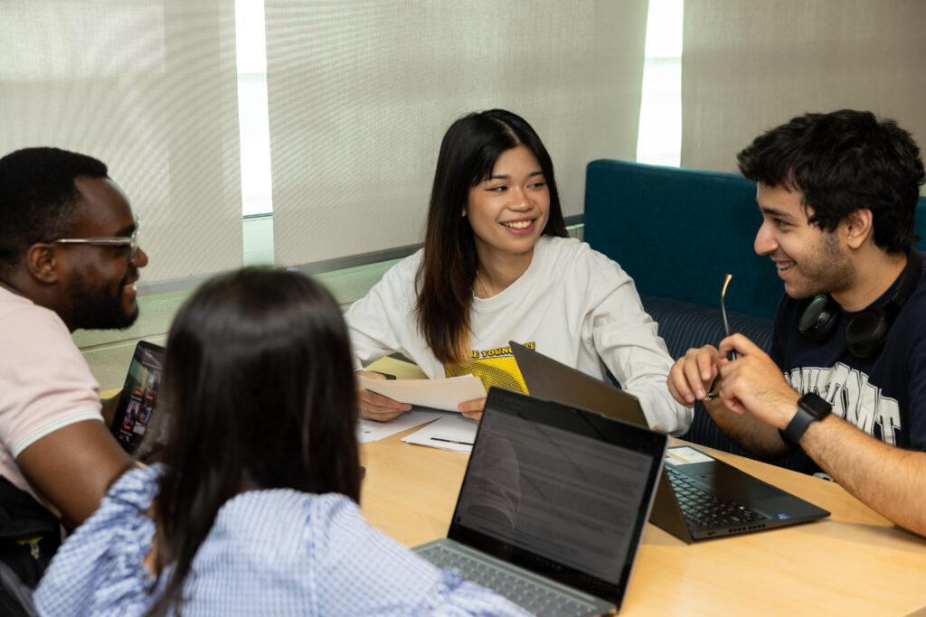 Four students sat a table conversing