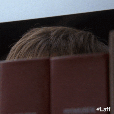 a man peeking over a fence