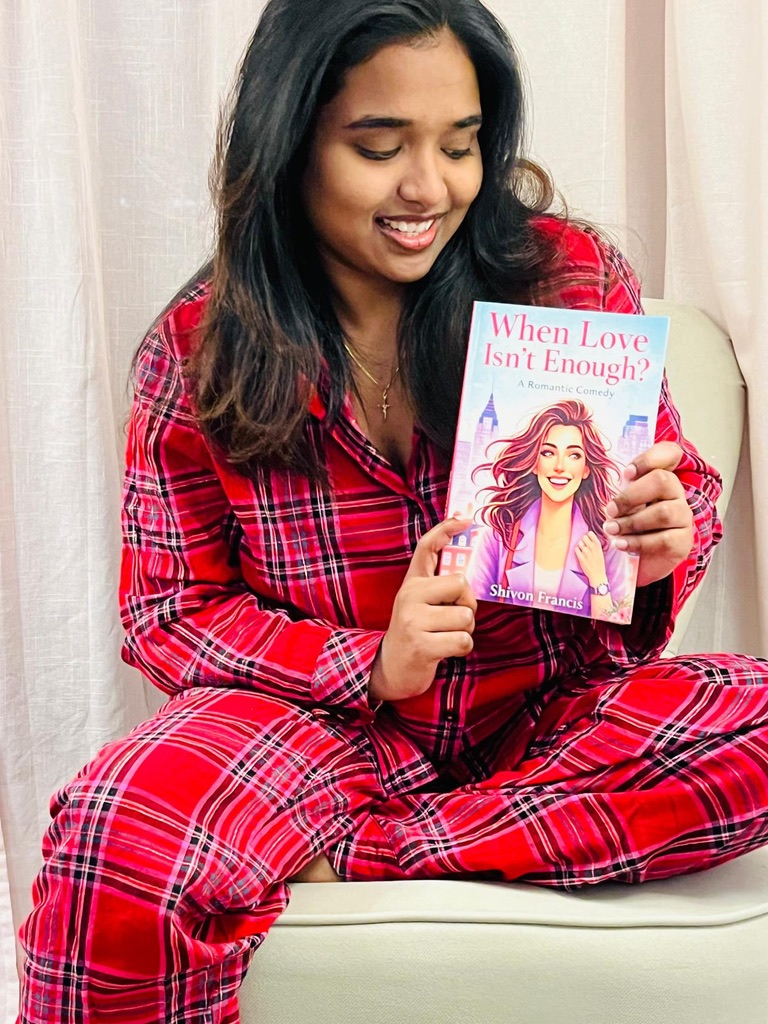 Shivon is holding her book, When Love Isn’t Enough.