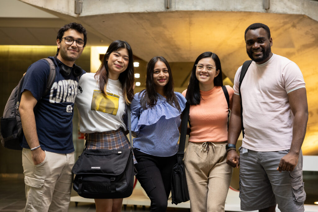 A picture of five students smiling at the camera