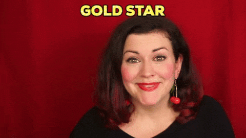A woman holding up a gold star