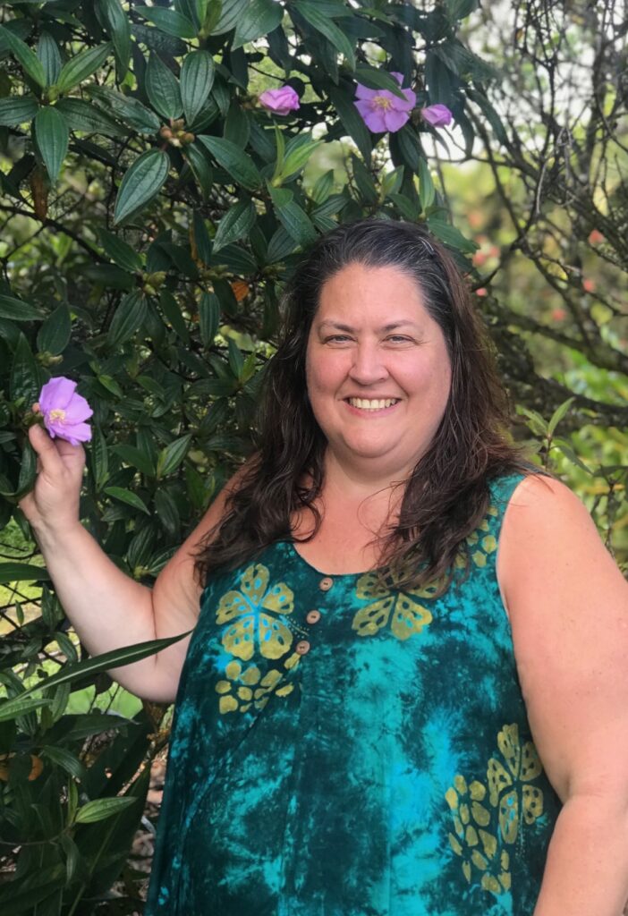 Laura's mother posing with plants.