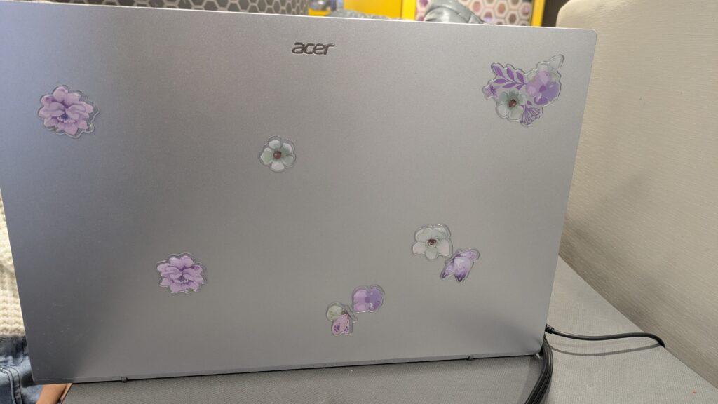 Anjali Paul's laptop with expressive purple flower stickers on it.