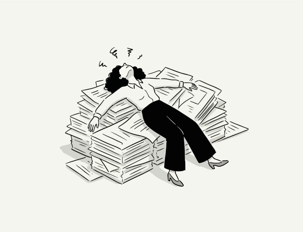 A person laying on a bed of papers.