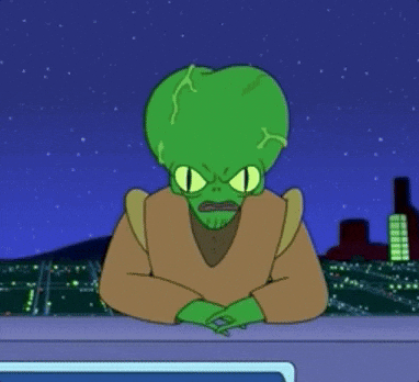 An alien news anchor from the TV show 'Futurama' screaming "Doom" toward the camera with his hands on the table.