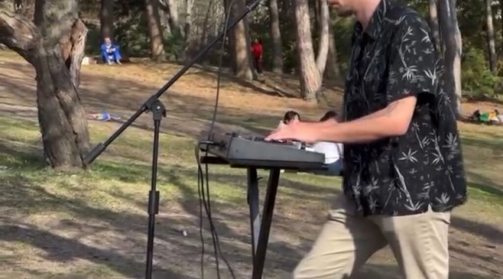 A man playing the piano at a park