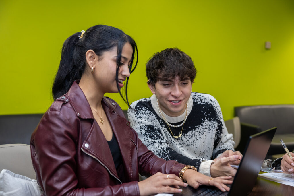 Two students sitting and talking to each other