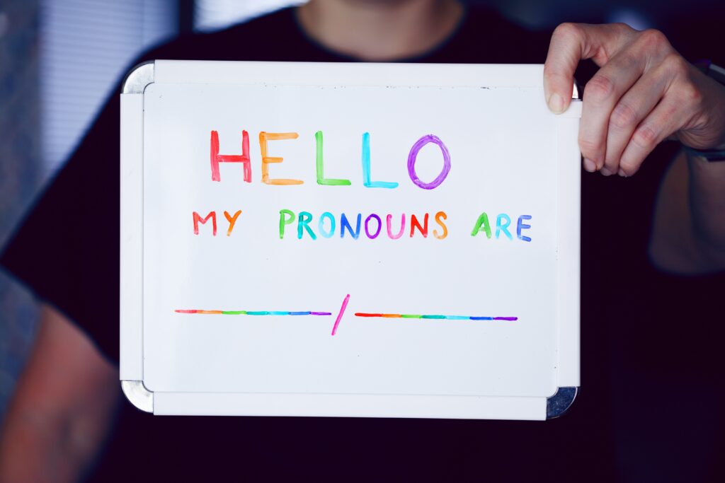 A white board reading "Hello, My pronouns are ___ / ___"