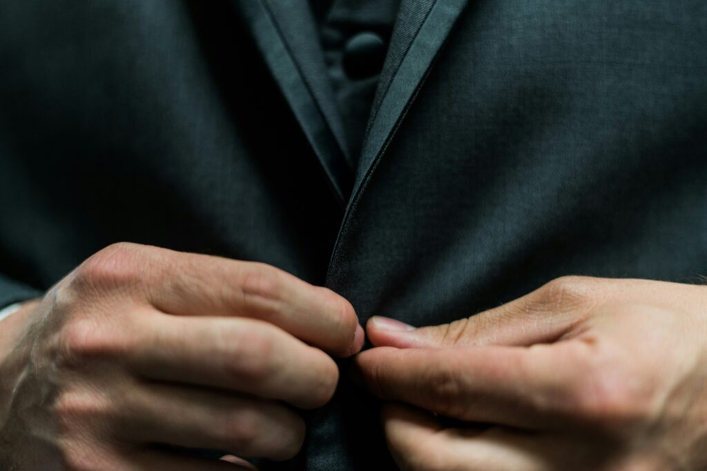 close up of a ma putting on a suit