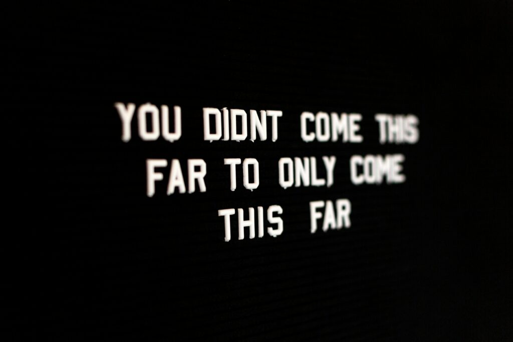 A dark screen with words reading "you didn't come this far only to come this far"
