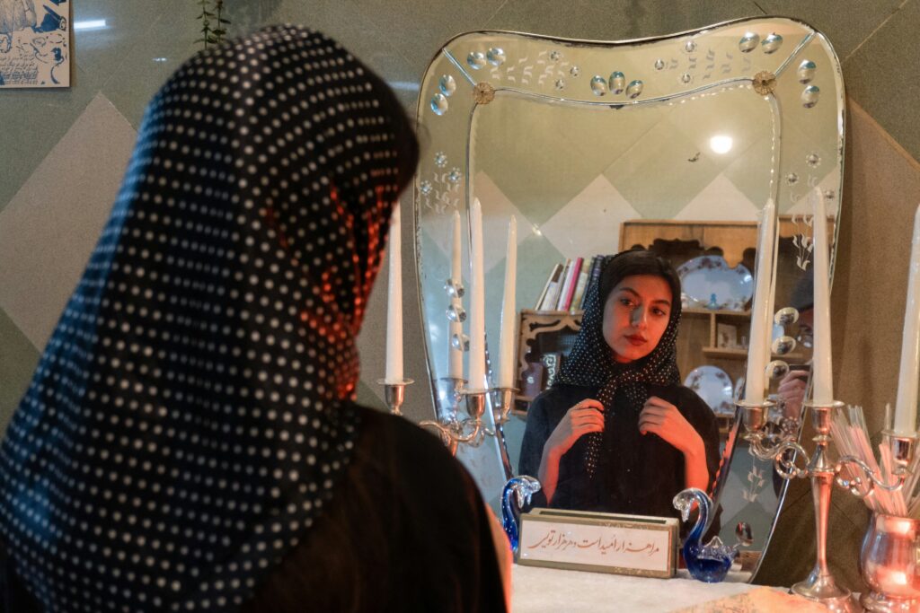 a woman looking at herself in the mirror