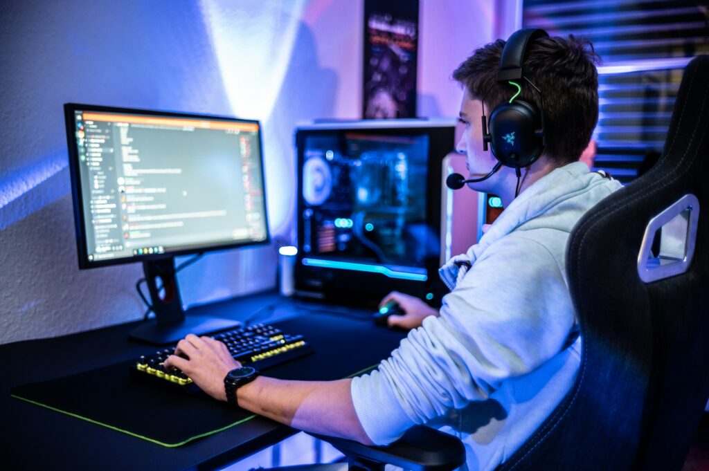 A man sitting and gaming on his computer