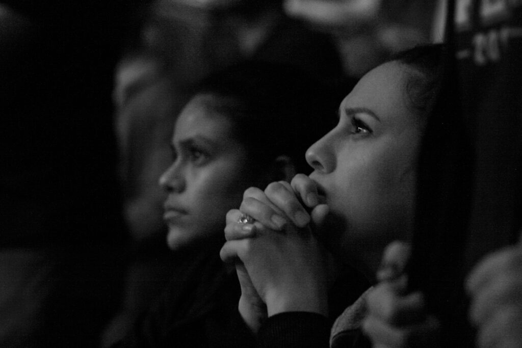 Black and white photo of people listening