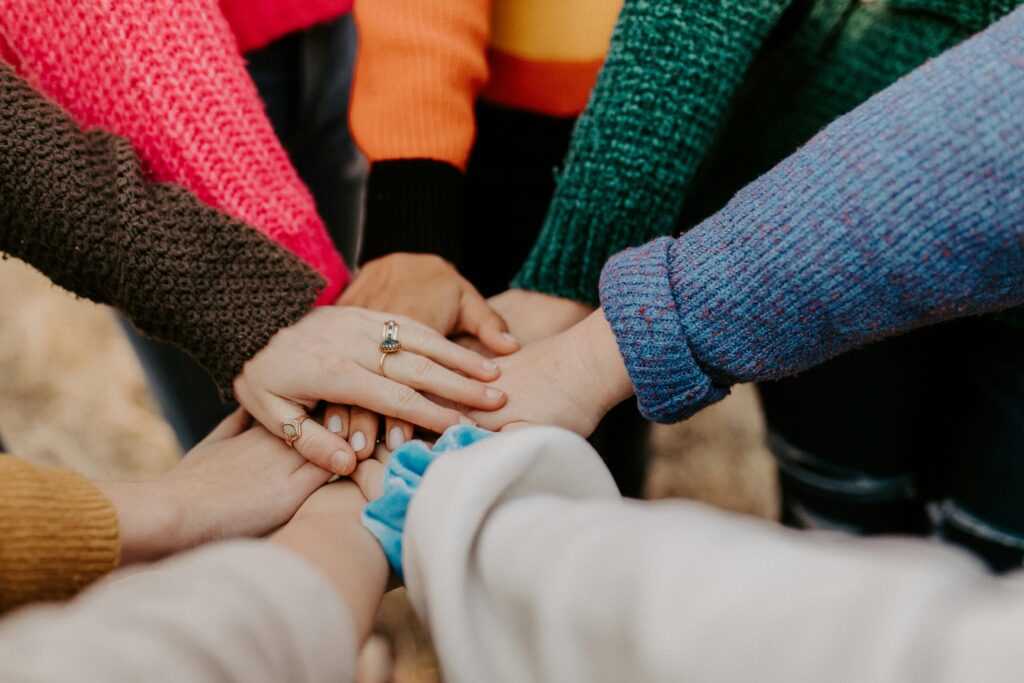 A bunch of hands placing their palms on top of each other