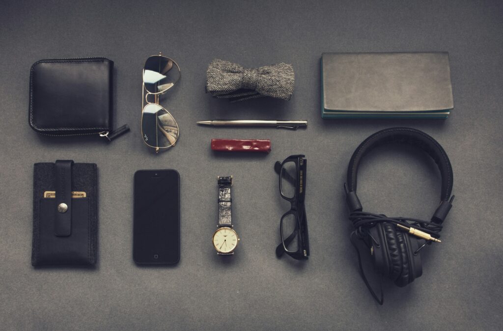 various accessories neatly laid out on a grey background