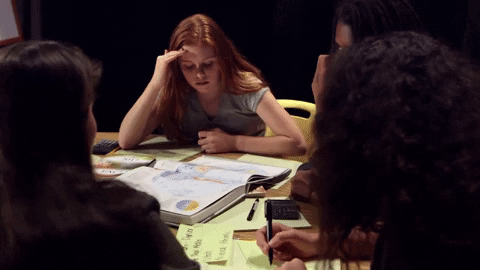 A group sat around a table stressed.